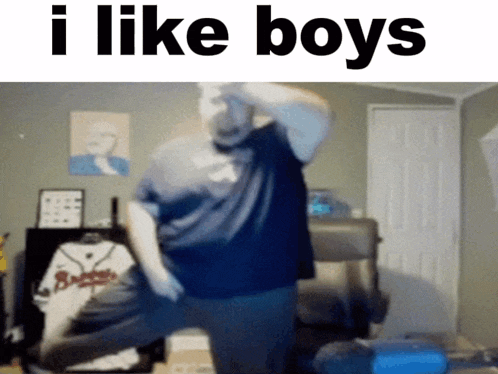 a man in a blue shirt is dancing with the words i like boys behind him