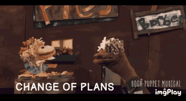 a blurred image of a puppet with the words change of plans above it
