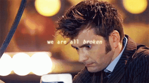 a man in a suit with the words we are all broken on his face .
