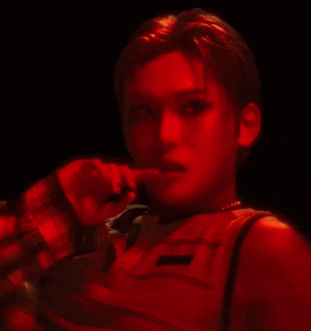 a close up of a person 's face with a red light shining on it .