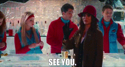 a group of people are standing around a bar and a woman is standing in front of a table with the words `` see you '' .