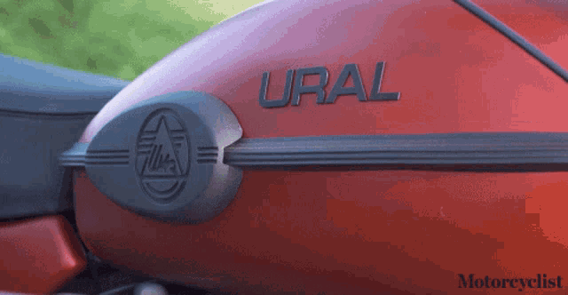 a red motorcycle with the word ural written on the side