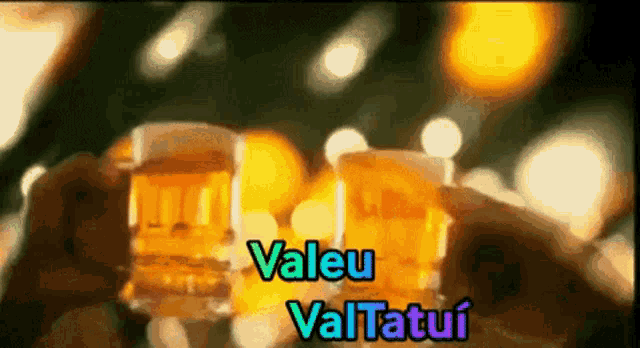 a person is holding a glass of beer with the words valeu vaitatui on the bottom