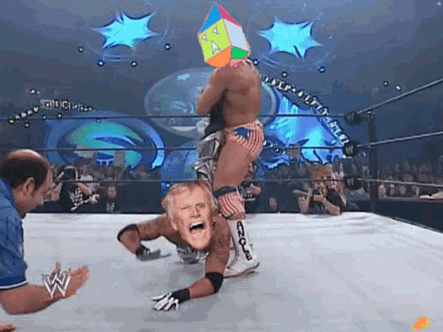 a man in a wrestling ring with the letter w on the bottom right