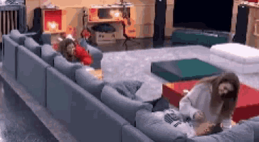 a woman is laying on a couch in a living room .