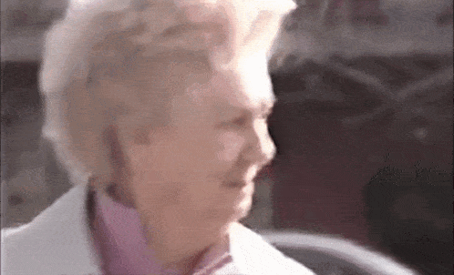a close up of an elderly woman 's face in a blurry photo