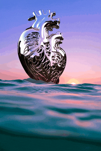 a metal heart is floating in the ocean