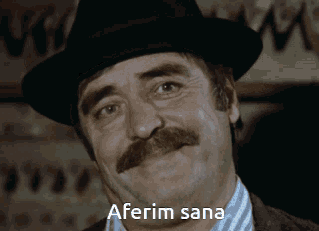 a man with a mustache wearing a hat has aferim sana written on his forehead