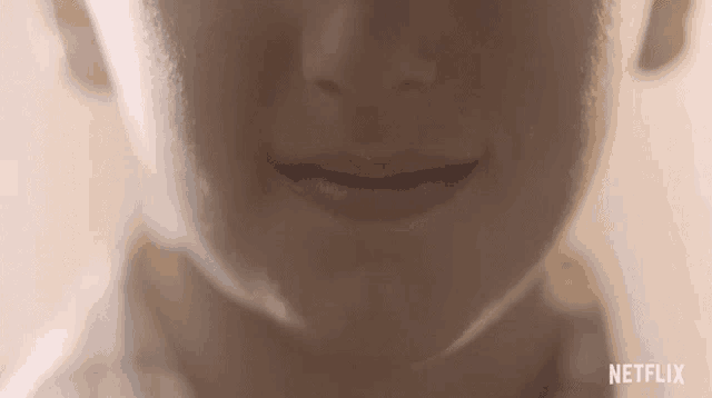 a close up of a person 's face with netflix written on the bottom right