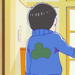 a boy in a blue sweater with a green leaf on his back