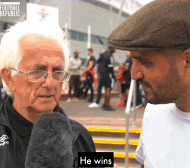 a man in a hat talks to an older man with the words he wins on the bottom