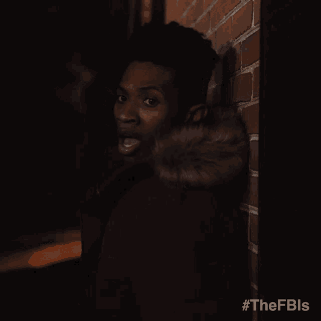 a man standing in front of a brick wall with the hashtag #thefbls on the bottom