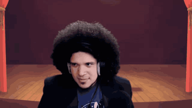 a man with a large afro wearing headphones