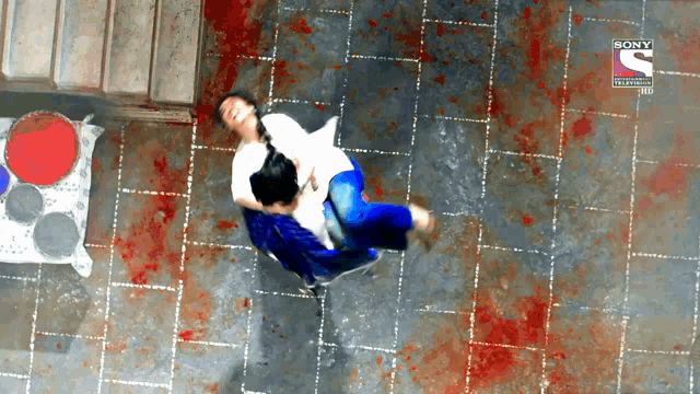 an ad for sony television shows a man carrying a woman in his arms