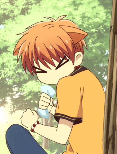 a boy with a cat ear on his head is sitting down