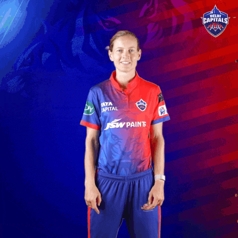 a woman is wearing a jersey that says ' delhi capitals ' on the front