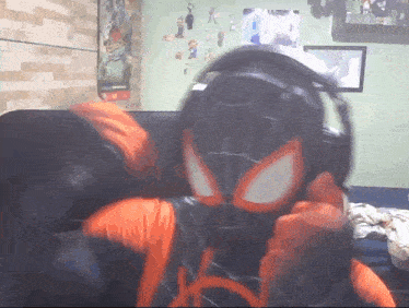 a person in a spider-man costume wearing headphones