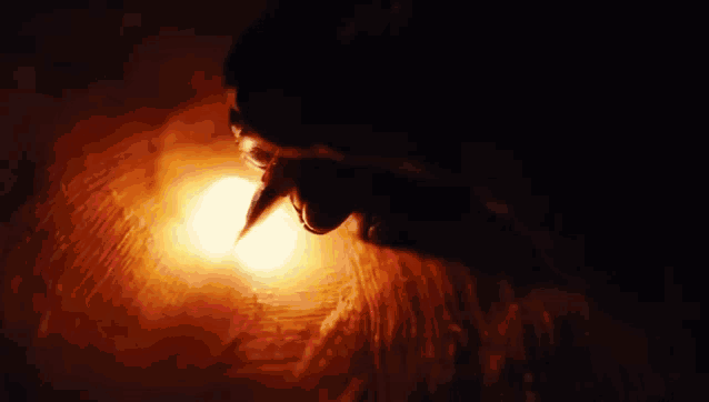 a close up of a person 's mouth with blood coming out of it in the dark .