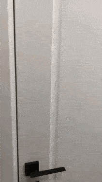 a close up of a person 's hand pressing a door knob .