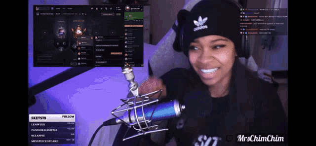 a woman wearing an adidas hat is smiling while playing a video game