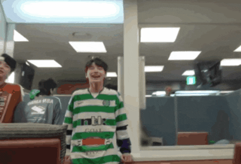 a man wearing a green and white celtic shirt