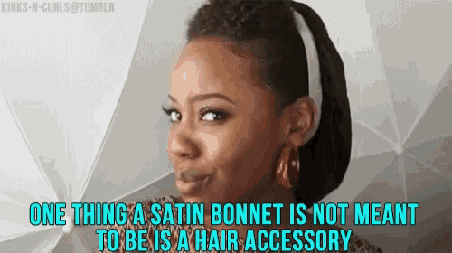 a woman is wearing a satin bonnet that is not meant to be a hair accessory .