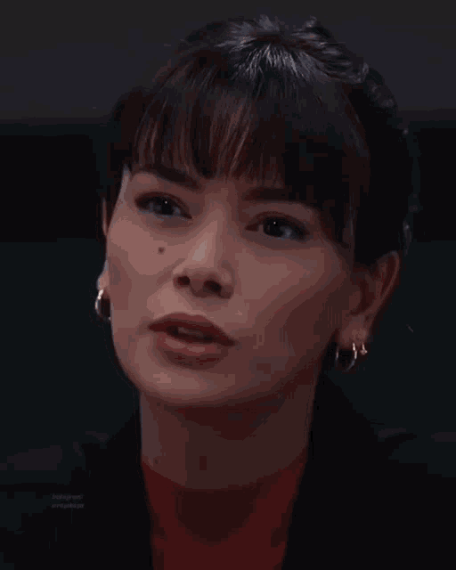 a close up of a woman 's face with a black background