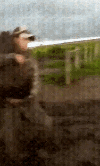 a blurry picture of a man with a hat on