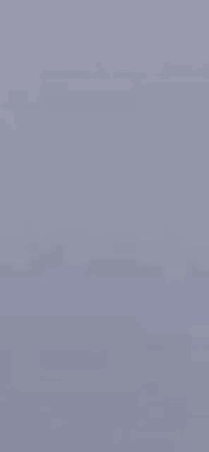 a close up of a gray background with a plain texture .