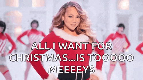 a woman in a santa outfit says all i want for christmas is toooo meeeys
