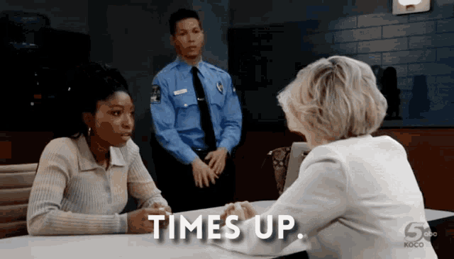 a woman sitting at a table with the words times up written on the table