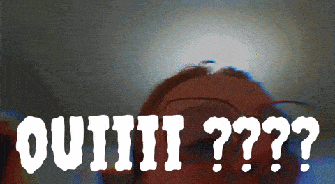 a blurry picture of a person with glasses and the words " ouiiii ?? "