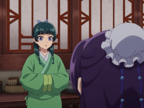 a girl in a green robe is standing next to another girl