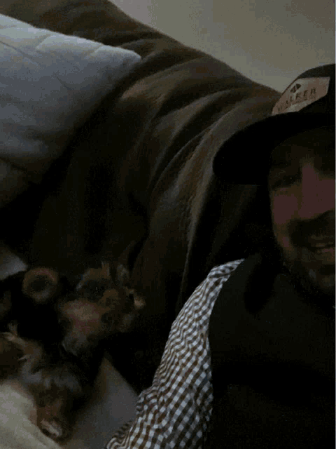 a man wearing a hat that says walker is laying on a couch