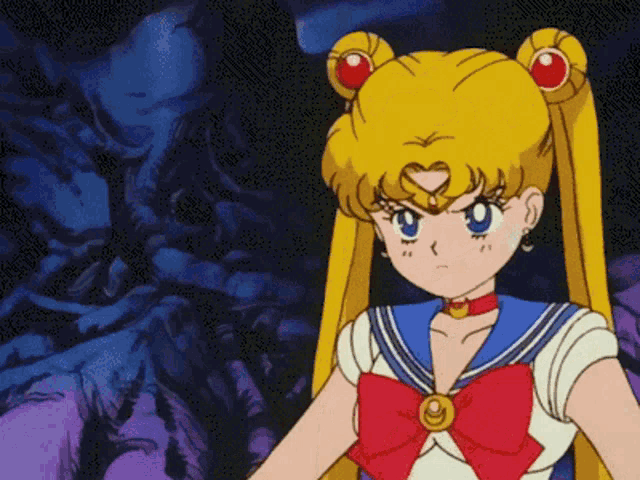 a sailor moon cartoon character with a red bow on her outfit