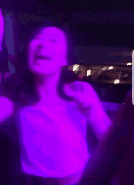 a blurry picture of a woman in a purple light