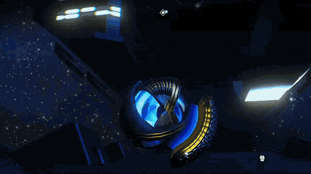 a blue object in a dark room with the letter s on the bottom right
