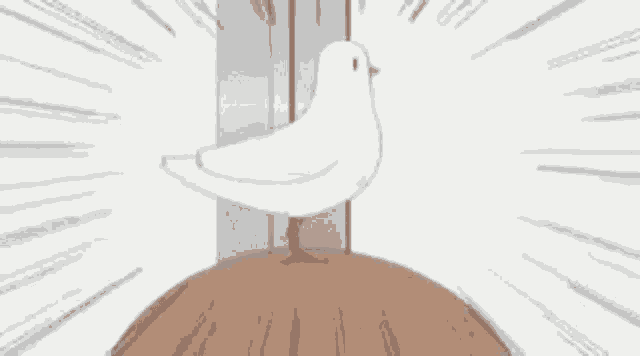 a white bird is standing on top of a wooden block .