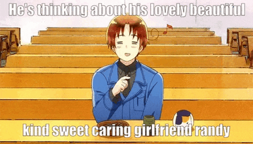 a man is sitting at a table in front of a row of bleachers with a volleyball .