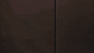 a close up of a man 's face in a dark room