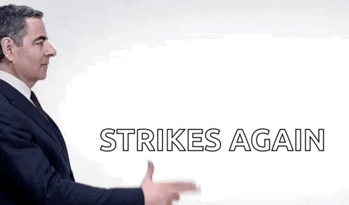 a man in a suit is pointing at something with the words strikes again below him