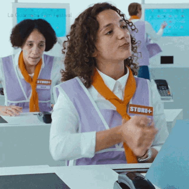 a woman wearing a purple apron that says store +