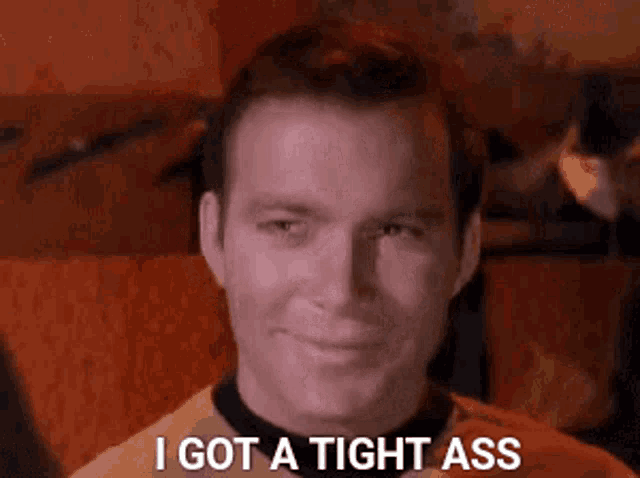 a close up of a man 's face with the words `` i got a tight ass '' written on it .