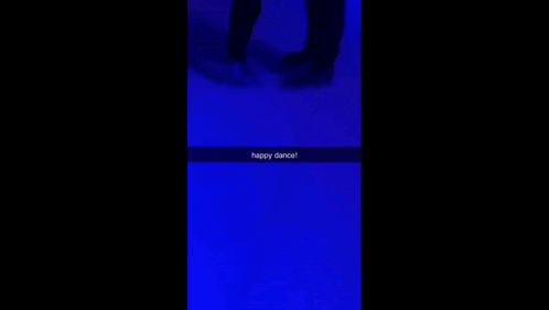 a couple of people standing next to each other in front of a blue background with the words `` happy dance '' written on it .