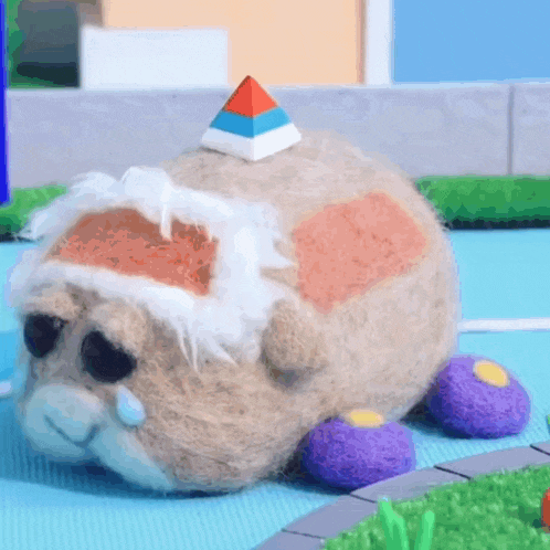 a stuffed animal with a pyramid on top of its head .