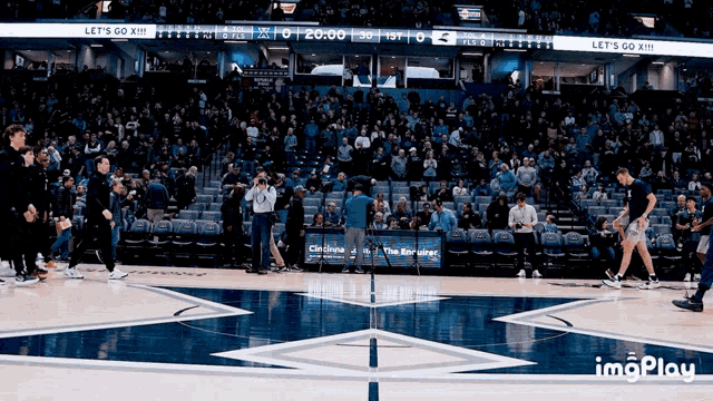 a basketball court with a banner that says let 's go xiii