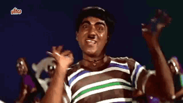 a man in a striped shirt is dancing in front of a sign that says ulira