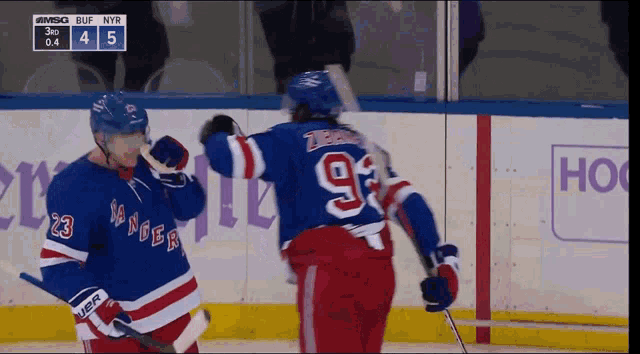 a hockey game is being played between the rangers and the blue jackets