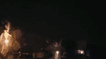 a lightning bolt is hitting a body of water in the dark .