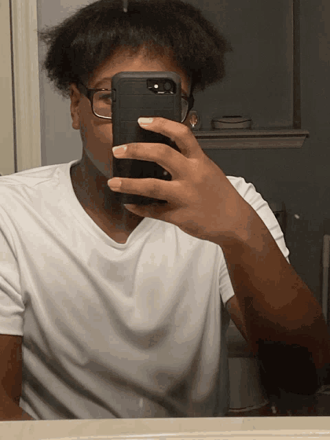 a young man taking a selfie with his phone